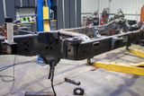 Wide angle, side view of the Rust Buster Rear Cab Mount For 2009-2014 Ford F-150 RB7019 installed to the frame rail