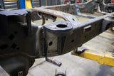 Side view of the Rust Buster Rear Cab Mount For 2009-2014 Ford F-150 RB7019 installed to the frame rail