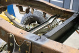 Rust Buster Spare Tire Crossmember Support For 1973-1987 Chevy C/K10 RB7362 installed between the frame rails, as seen from the back right side of the truck