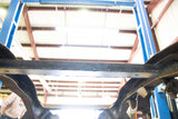 View from beneath Rust Buster Spare Tire Crossmember Support For 1973-1987 Chevy C/K10 RB7362 installed between the frame rails